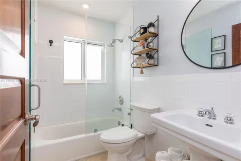 a bathroom with a toilet sink and tub