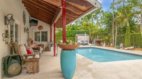 a view of a patio with table and chairs and potted plants