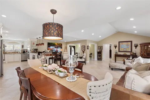 a living room with furniture a table and chairs