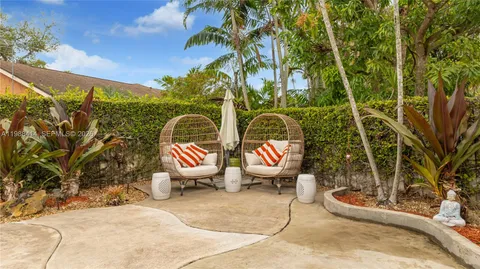 a view of a chairs and table in backyard