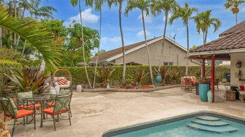 a backyard of a house with barbeque oven table and chairs