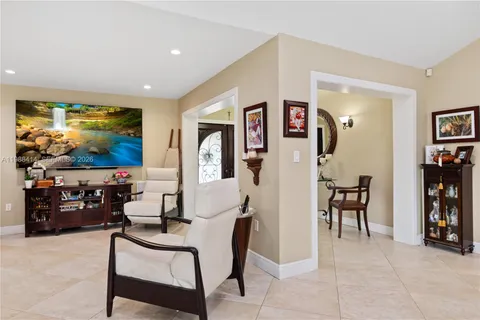 a living room with furniture a rug and a flat screen tv