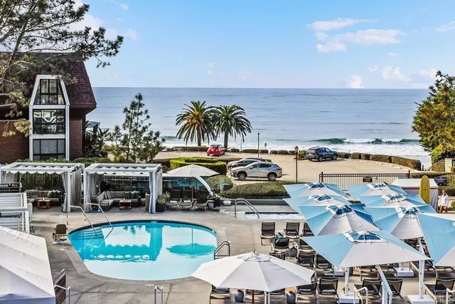 a view of a swimming pool with outdoor seating