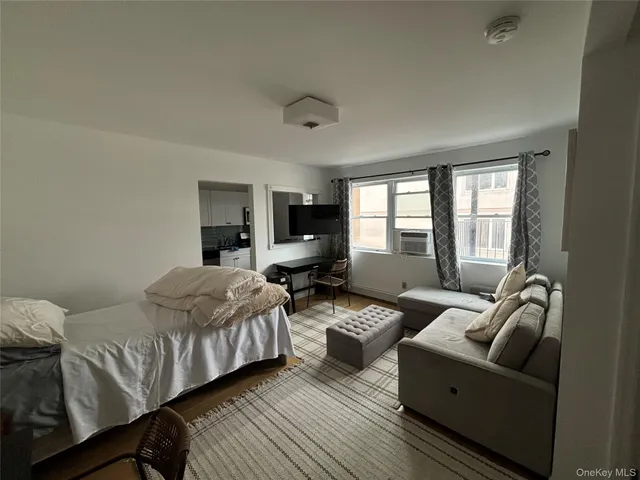 a bedroom with furniture and a large window