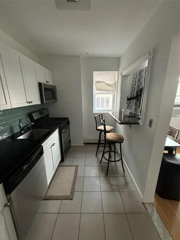 a kitchen with granite countertop a stove a sink and a granite counter top