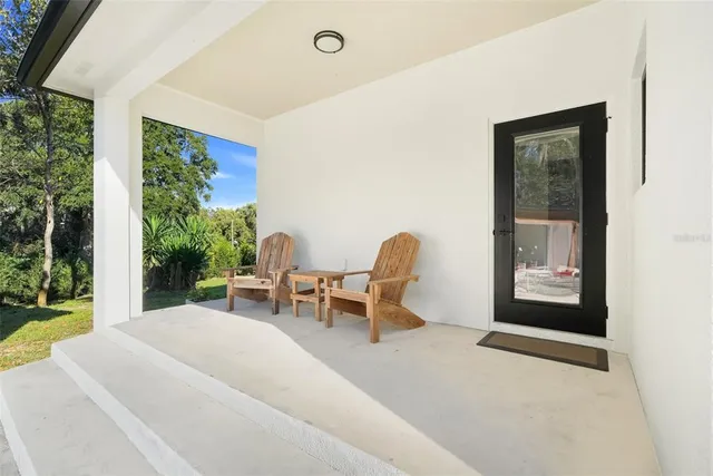 a view of backyard with a patio and outdoor seating