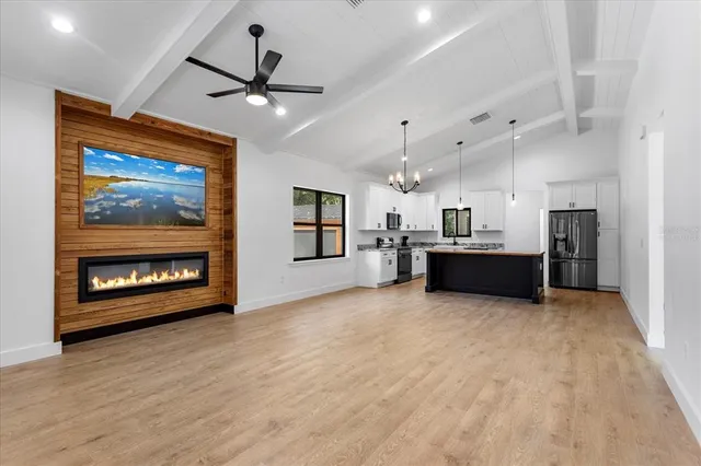 a view of a kitchen with a sink and a fireplace