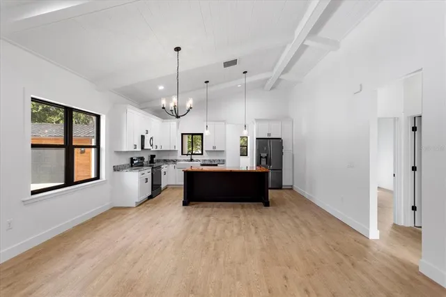 a large white kitchen with a large window