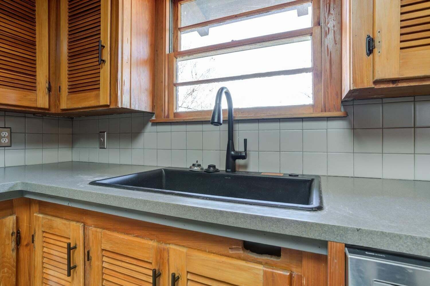 3410 40th Street Lubbock, TX 79413 - Photo 12 of 29 a kitchen with a sink and a window