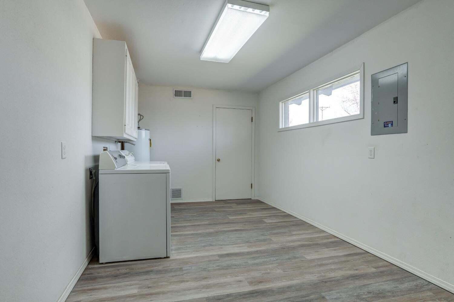 3410 40th Street Lubbock, TX 79413 - Photo 16 of 29 a utility room with wooden floor washer and dryer