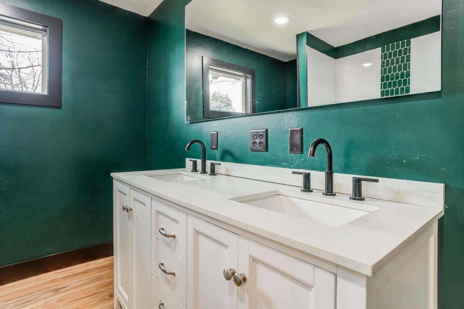 3410 40th Street Lubbock, TX 79413 - Photo 19 of 29 a bathroom with a sink and a mirror