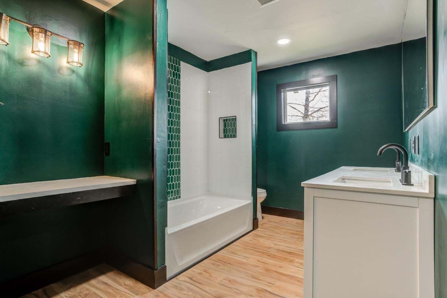 3410 40th Street Lubbock, TX 79413 - Photo 20 of 29 a bathroom with a sink a toilet and a mirror