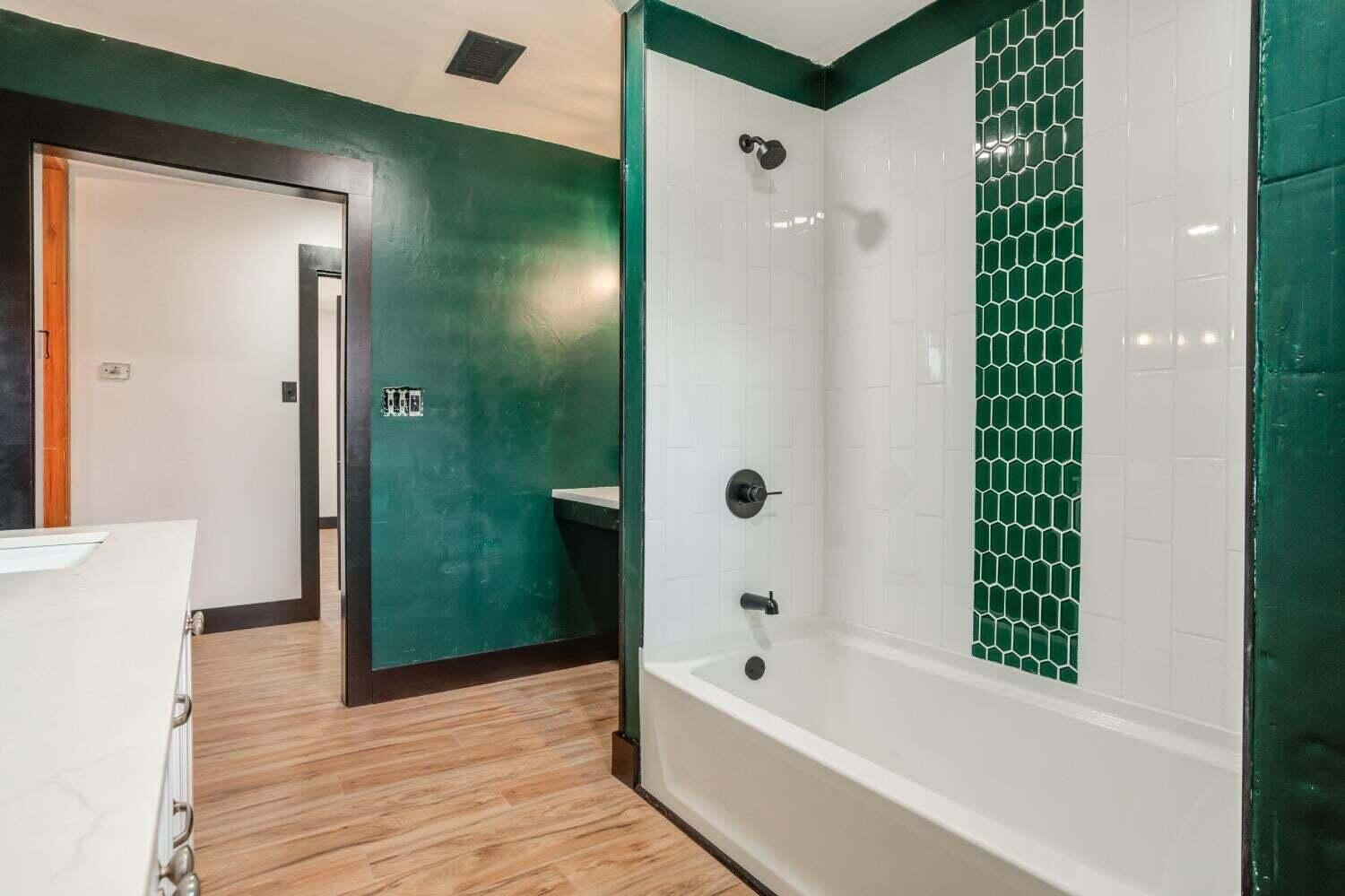 3410 40th Street Lubbock, TX 79413 - Photo 21 of 29 a bathroom with a bathtub and a shower