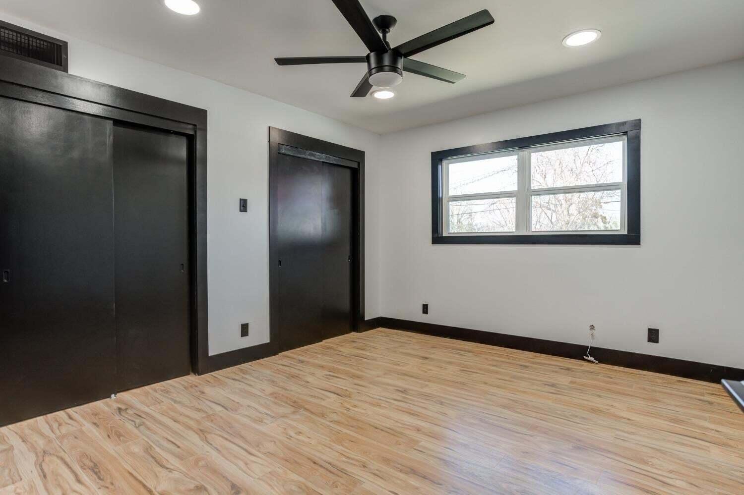 3410 40th Street Lubbock, TX 79413 - Photo 22 of 29 a view of empty room with wooden floor and fan