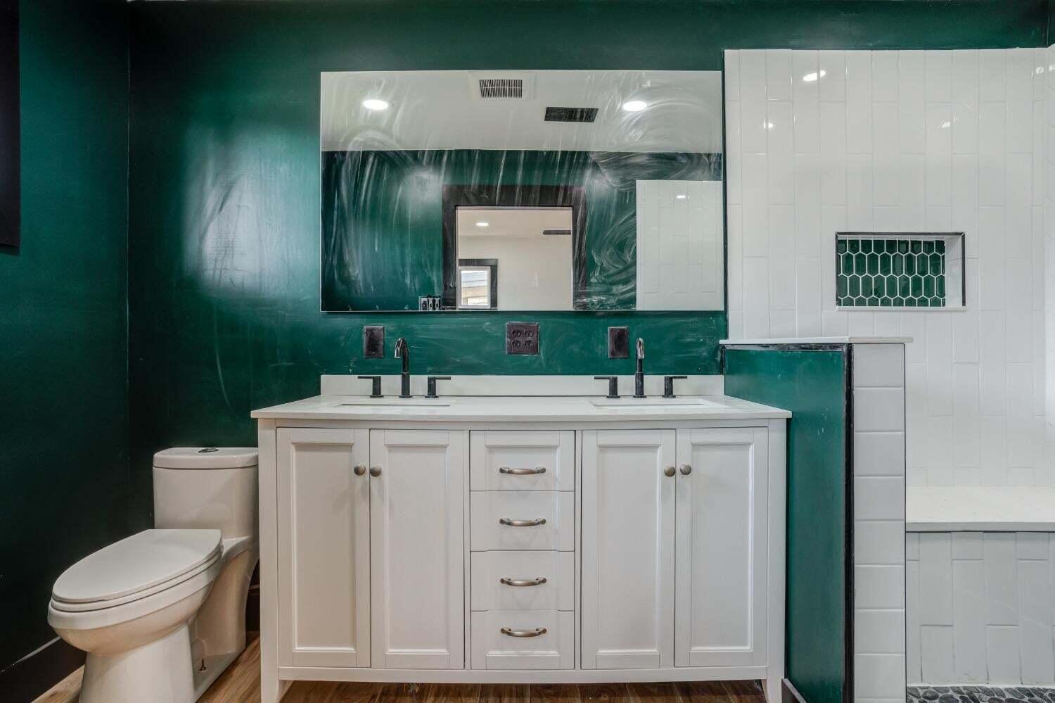 3410 40th Street Lubbock, TX 79413 - Photo 27 of 29 a bathroom with a sink and a mirror