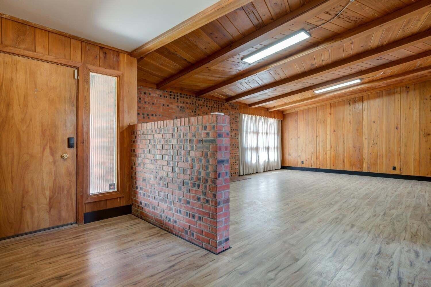 3410 40th Street Lubbock, TX 79413 - Photo 6 of 29 a view of an empty room with wooden floor and a window