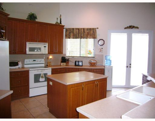5000 Southwest 198th Terrace Southwest Ranches, FL 33332 - Photo 5 of 16 a kitchen with stainless steel appliances granite countertop a sink stove and refrigerator