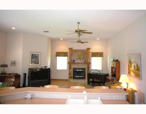 5000 Southwest 198th Terrace Southwest Ranches, FL 33332 - Photo 6 of 16 a living room with furniture a fireplace and a flat screen tv