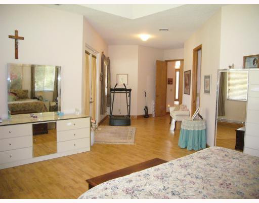 5000 Southwest 198th Terrace Southwest Ranches, FL 33332 - Photo 10 of 16 a spacious bedroom with a bed and cabinets