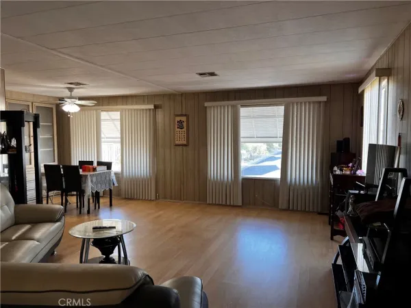 a livingroom with furniture a piano and wooden floor