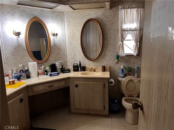 a bathroom with a toilet sink and mirror