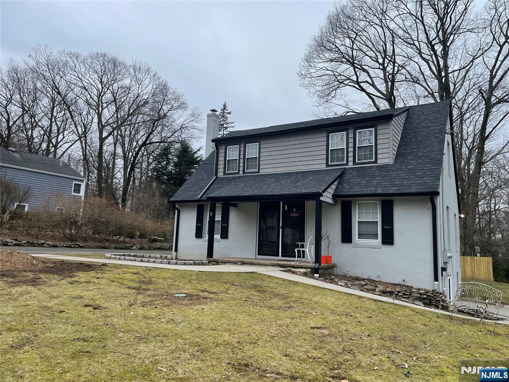 9 B Cottage Lane, Unit B Upper Saddle River, NJ 07458 - Photo 2 of 13 a front view of a house with a yard