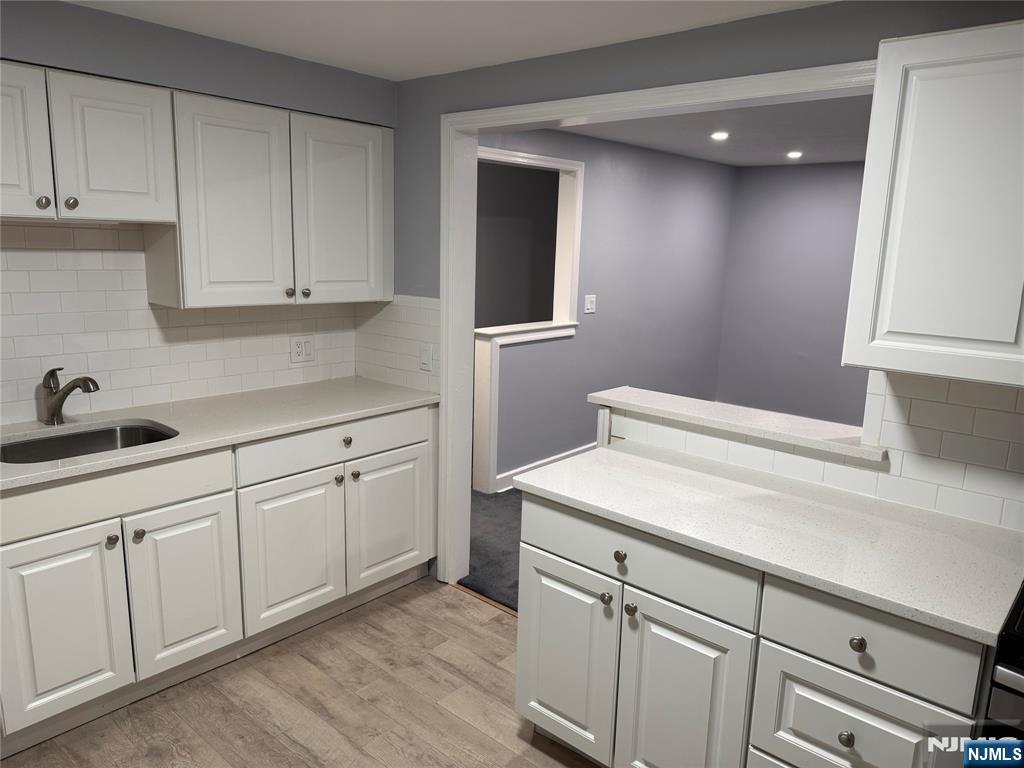 9 B Cottage Lane, Unit B Upper Saddle River, NJ 07458 - Photo 4 of 13 a kitchen with white cabinets and sink