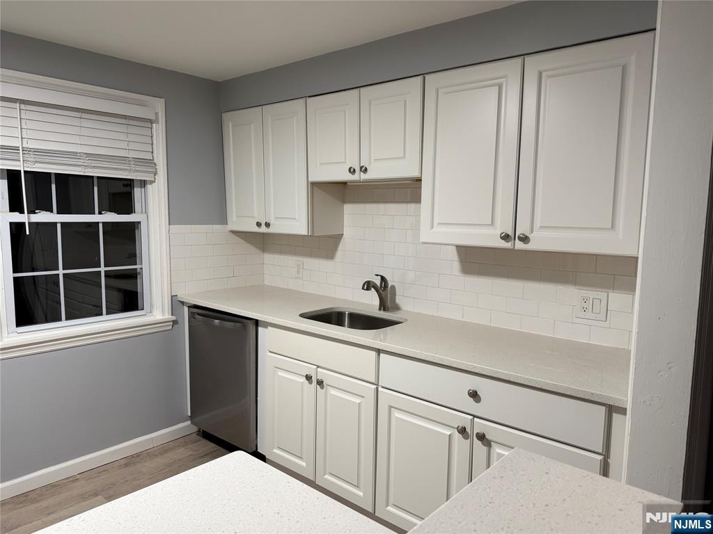 9 B Cottage Lane, Unit B Upper Saddle River, NJ 07458 - Photo 5 of 13 a kitchen with white cabinets and window