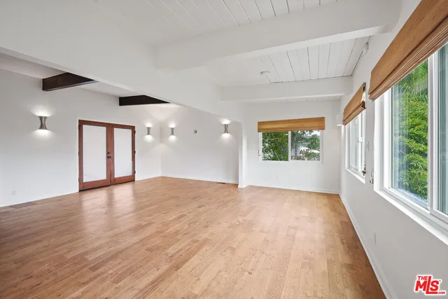 a view of a living room and kitchen floor with a floor to ceiling window