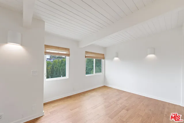 a living room with stainless steel appliances kitchen island granite countertop a refrigerator and a stove top oven