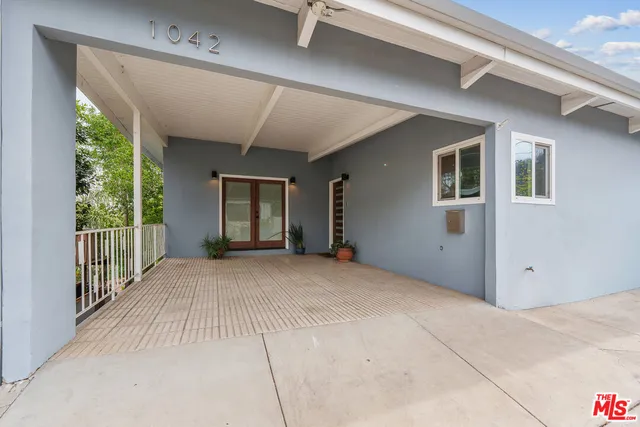 a kitchen with stainless steel appliances granite countertop a refrigerator a sink a stove and oven