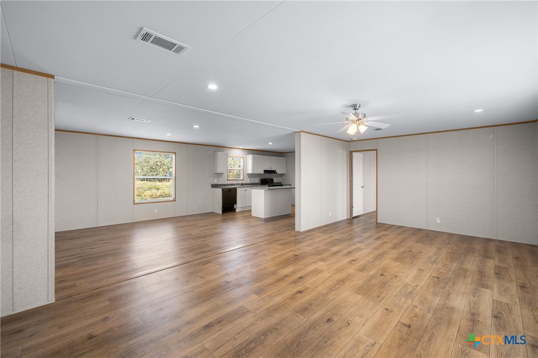 139 Azalea Ct Dale Dale, TX 78616 - Photo 11 of 26 a view of empty room with kitchen and window