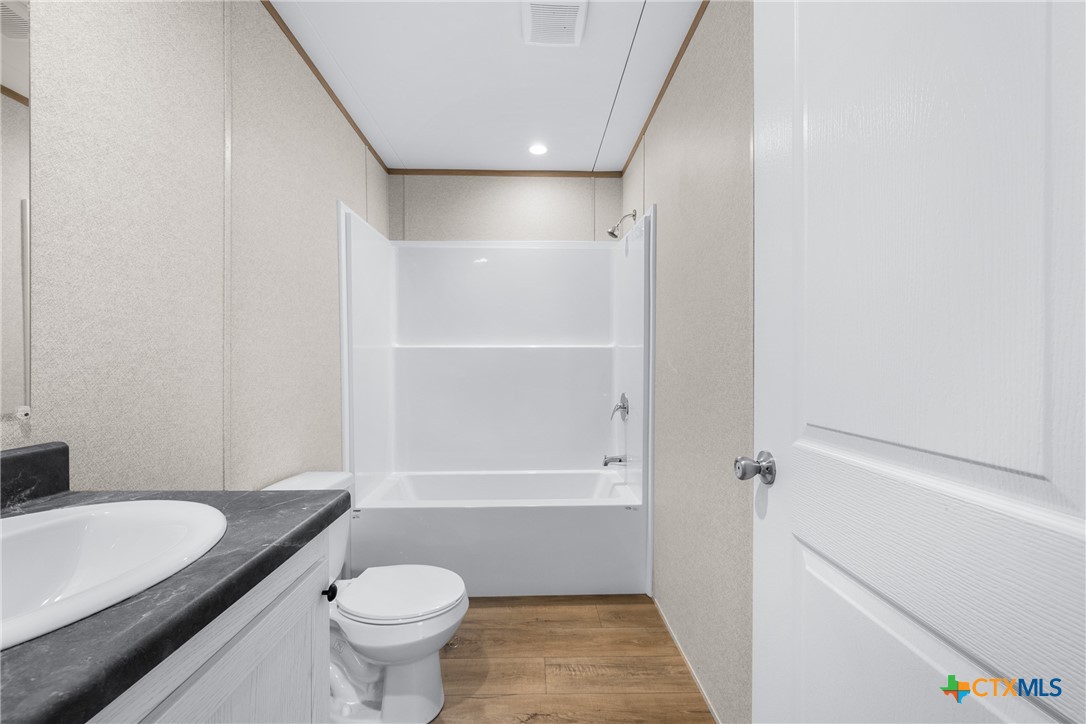 139 Azalea Ct Dale Dale, TX 78616 - Photo 17 of 26 a bathroom with a sink a toilet and shower