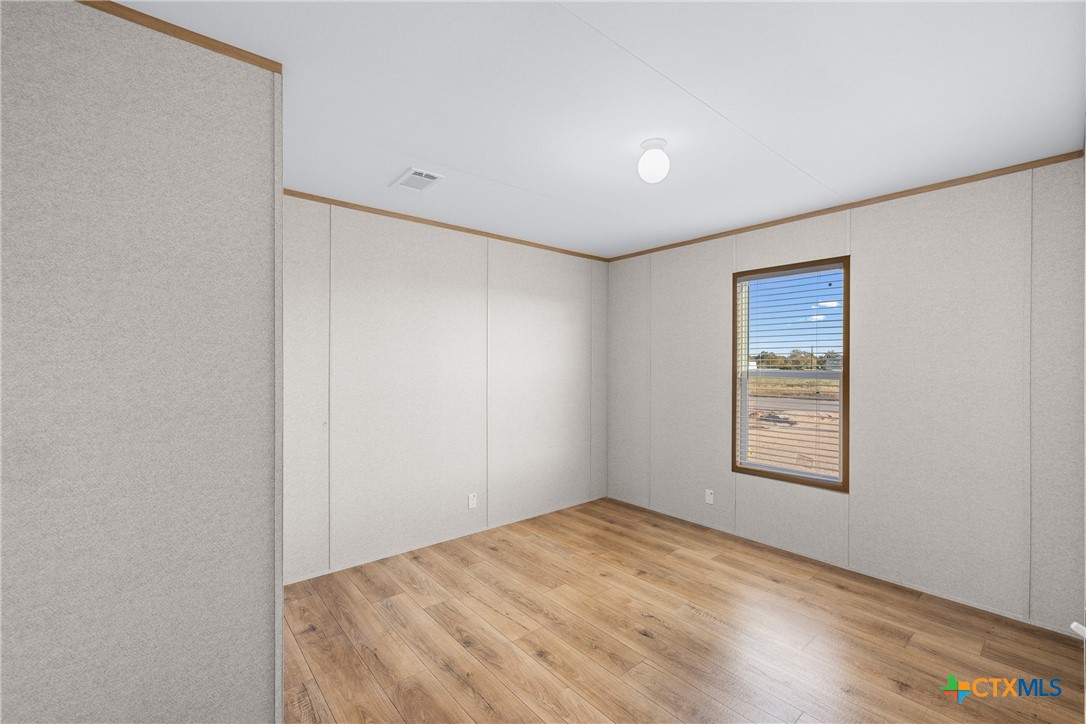 139 Azalea Ct Dale Dale, TX 78616 - Photo 23 of 26 an empty room with windows and closet