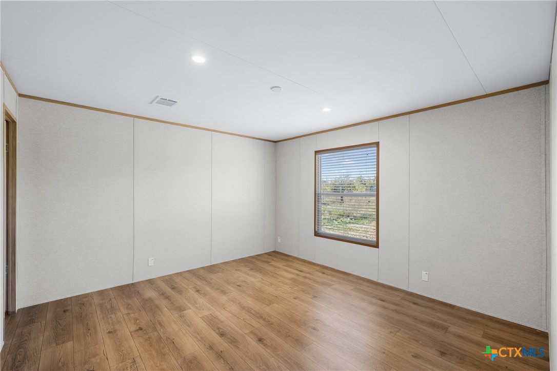 139 Azalea Ct Dale Dale, TX 78616 - Photo 24 of 26 an empty room with windows and closet