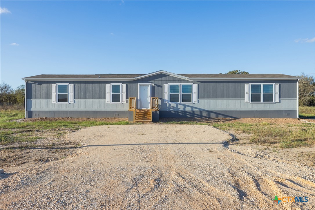 139 Azalea Ct Dale Dale, TX 78616 - Photo 3 of 26 a front view of a house with yard