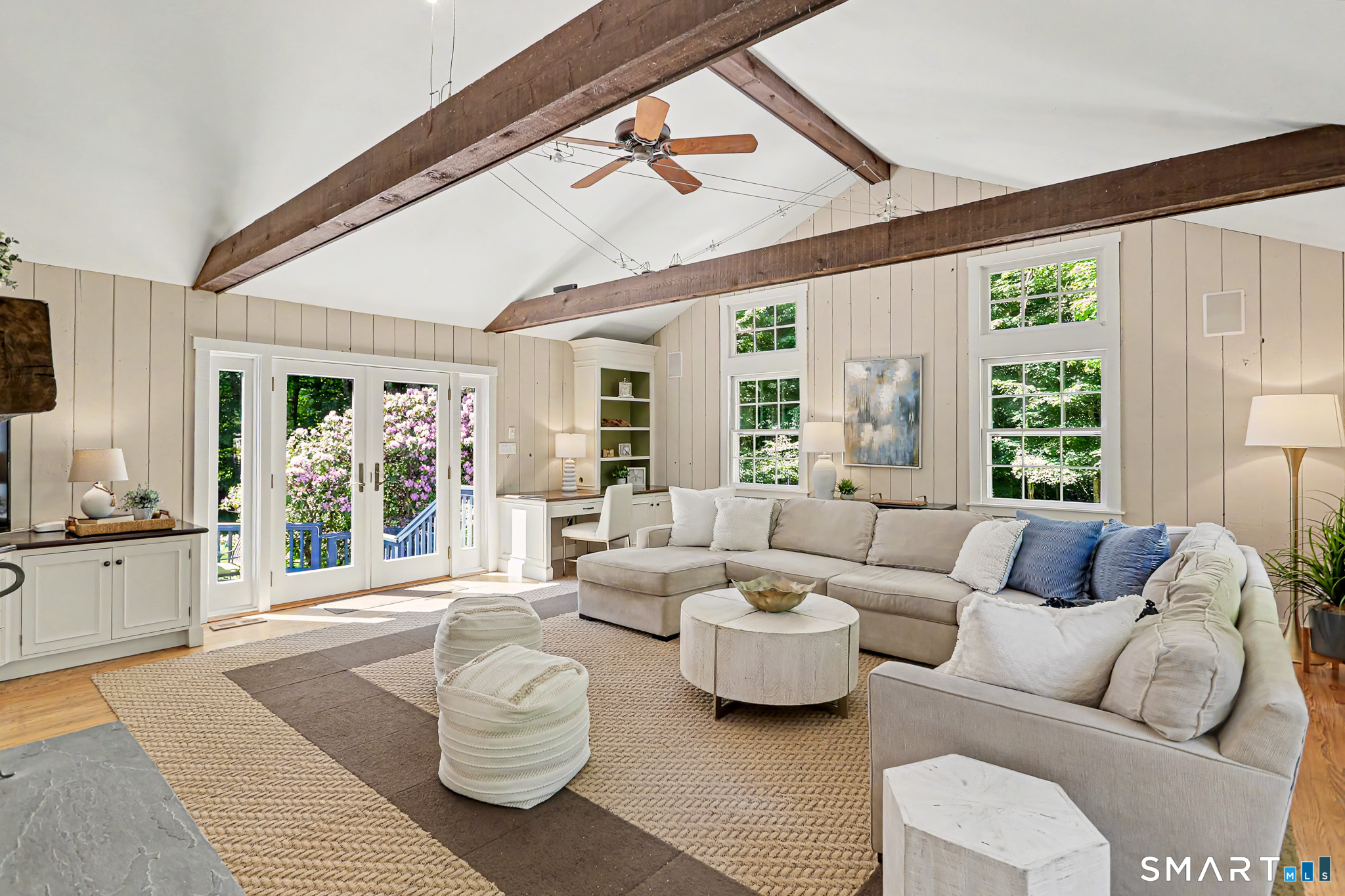 6 Adams Way Weston, CT 06883 - Photo 14 of 40 The dramatic yet cozy family room with a vaulted ceiling, beams, and a door to a second deck.