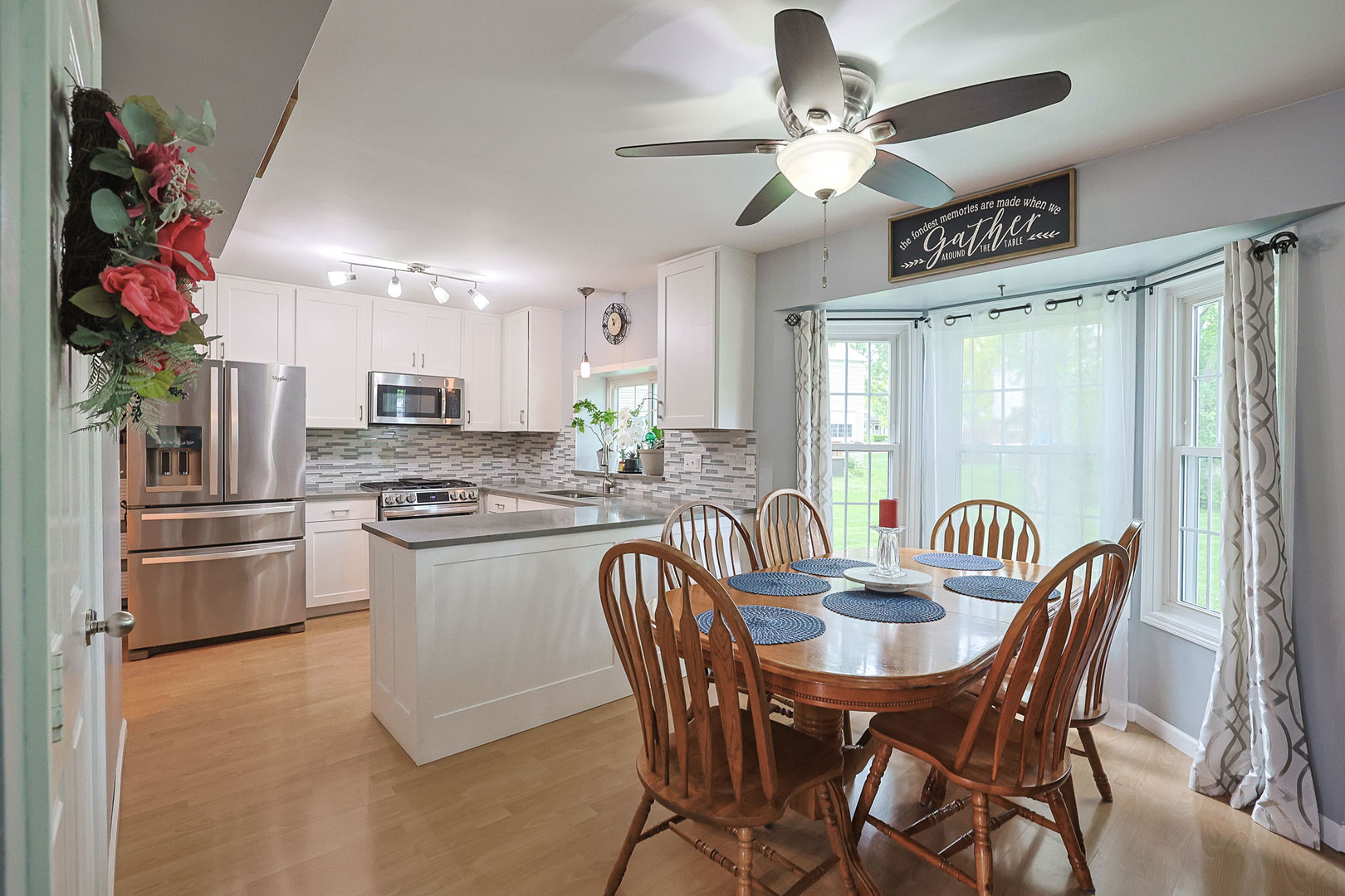 830 Hawk Lane Carol Stream, IL 60188 - Photo 5 of 30 a kitchen with stainless steel appliances granite countertop a sink a stove a refrigerator cabinets and dining table