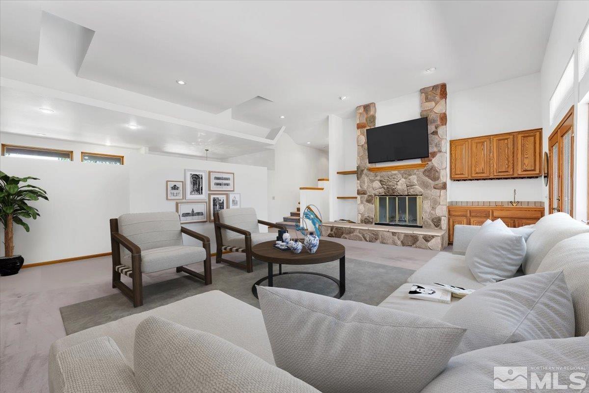 4285 Bitteroot Road Reno, NV 89519 - Photo 12 of 40 a living room with furniture a flat screen tv and a fireplace