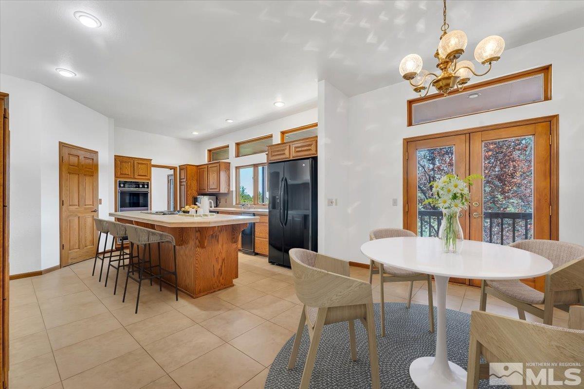 4285 Bitteroot Road Reno, NV 89519 - Photo 14 of 40 a dining room with furniture a rug and a chandelier