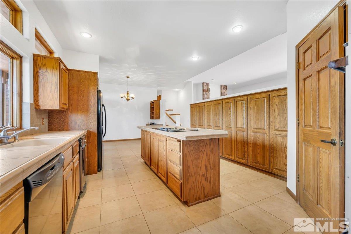 4285 Bitteroot Road Reno, NV 89519 - Photo 16 of 40 a kitchen with stainless steel appliances granite countertop a stove a sink and a refrigerator