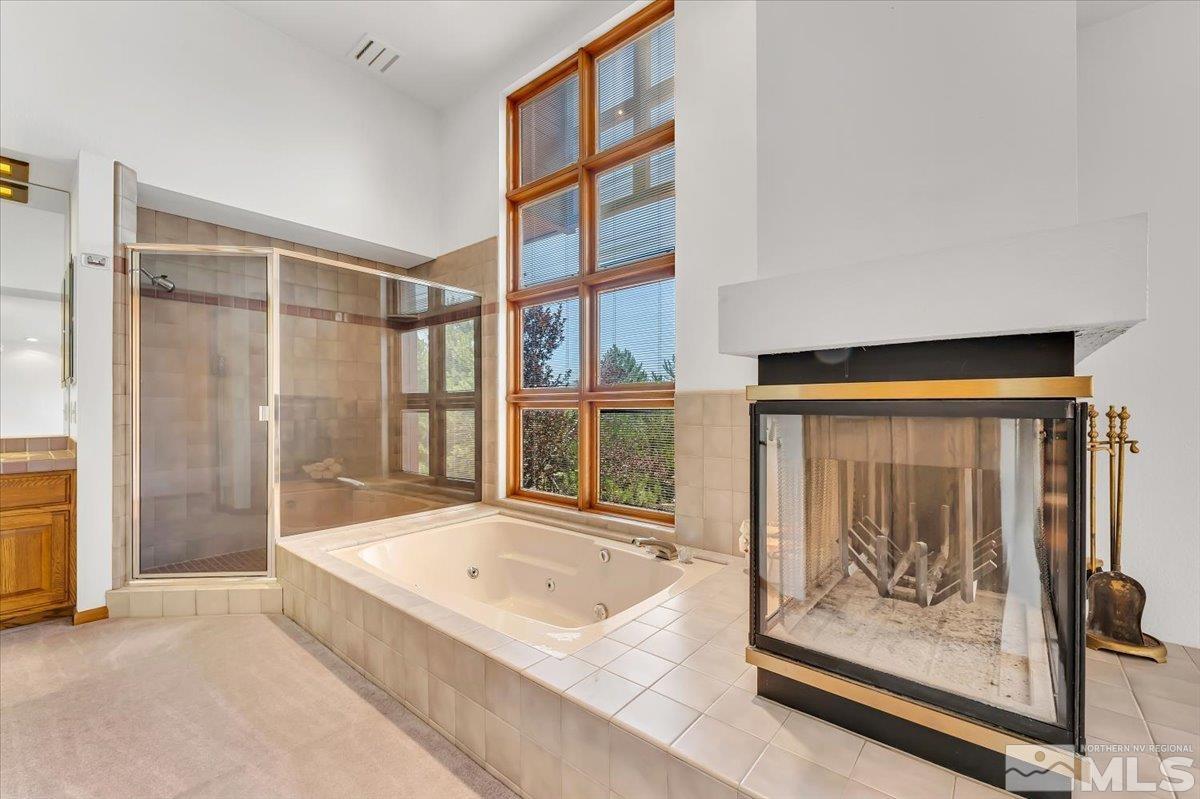 4285 Bitteroot Road Reno, NV 89519 - Photo 19 of 40 a bathroom with a tub and a shower