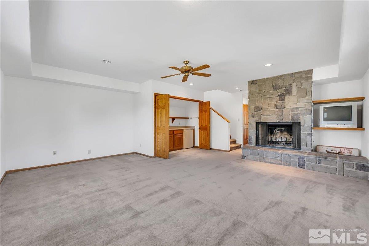 4285 Bitteroot Road Reno, NV 89519 - Photo 23 of 40 an empty room with fireplace and fan