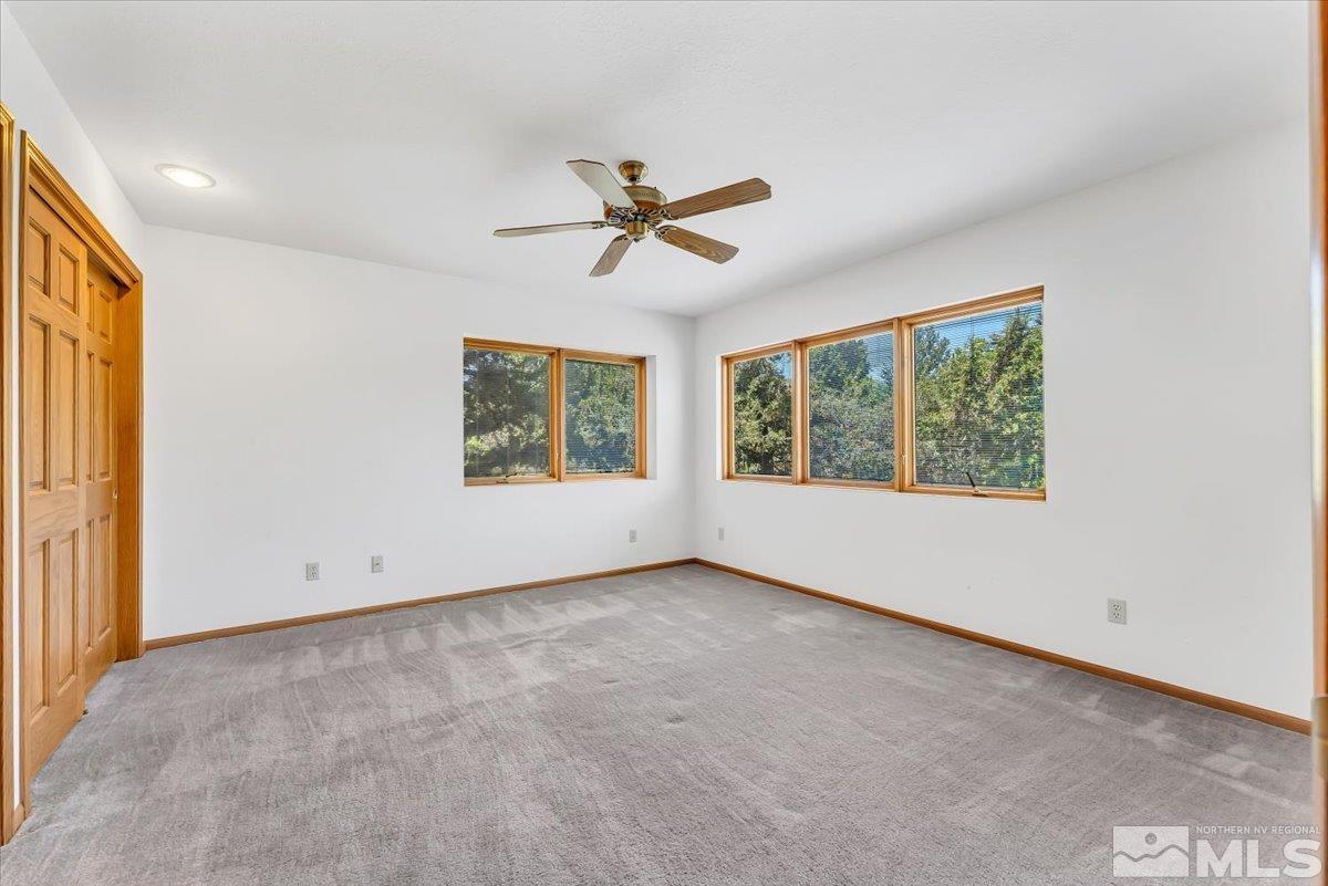 4285 Bitteroot Road Reno, NV 89519 - Photo 26 of 40 an empty room with windows and ceiling fan