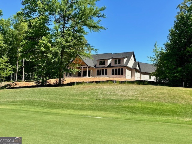 106 Equestrian Drive Forsyth, GA 31029 - Photo 19 of 52 a front view of a house with a garden