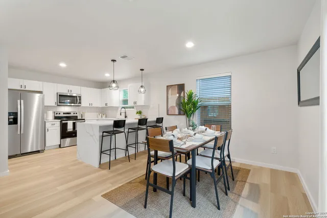 a view of a dining room with furniture and wooden floor