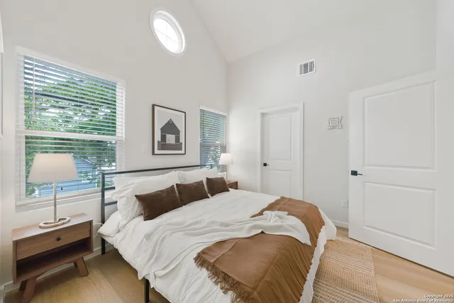 a bedroom with a bed and a lamp