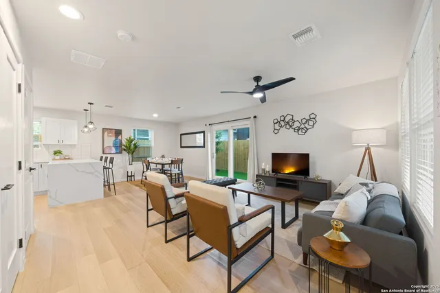 a living room with furniture a fireplace and a flat screen tv
