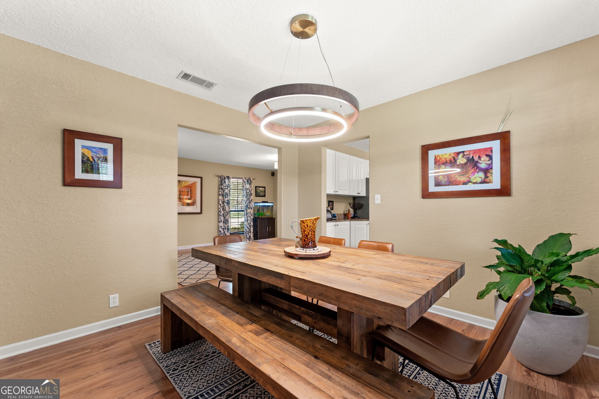 323 St Marys River Bluff Road St. George, GA 31562 - Photo 11 of 43 a view of a dining room with furniture and wooden floor