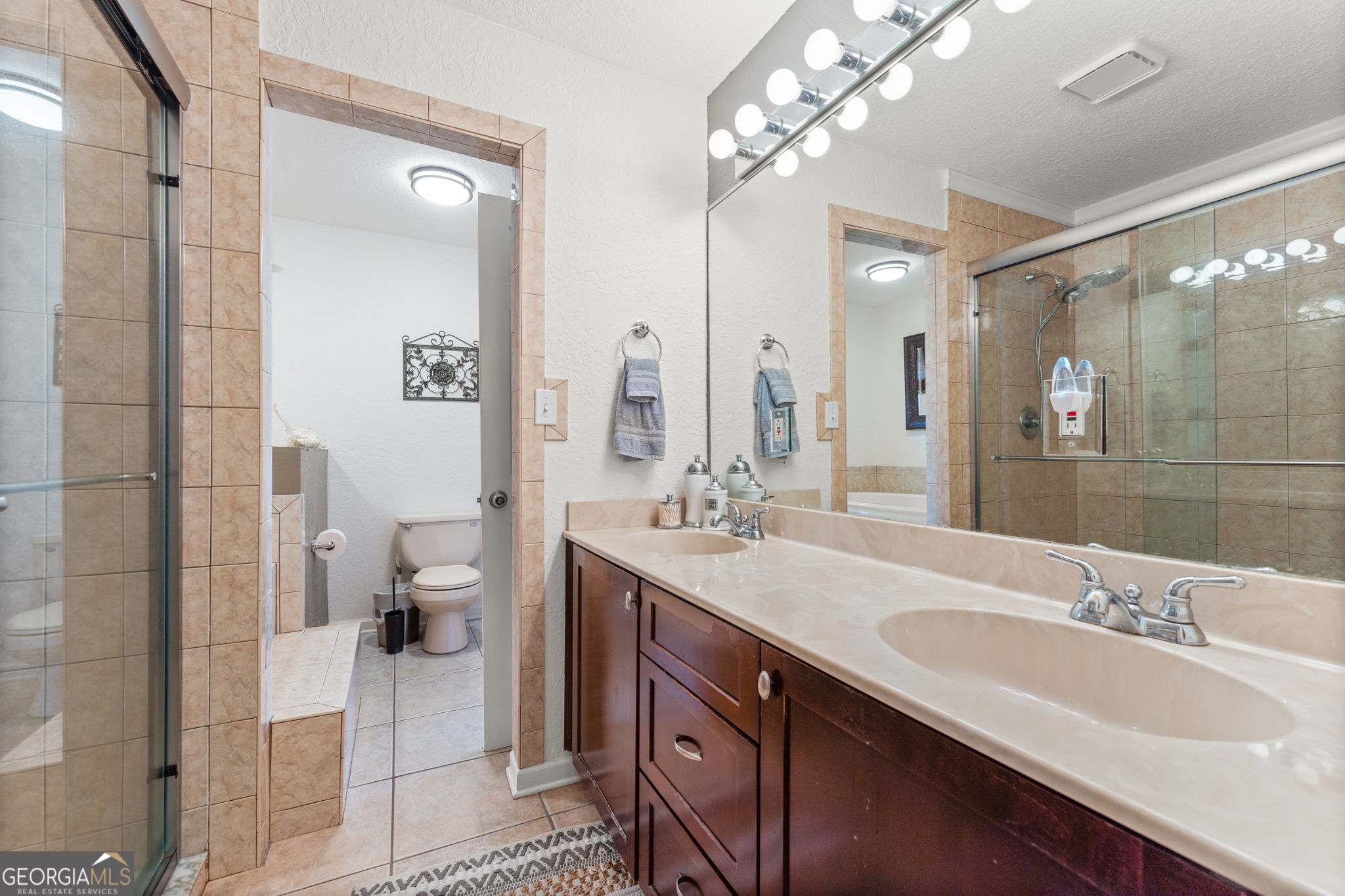 323 St Marys River Bluff Road St. George, GA 31562 - Photo 21 of 43 a spacious bathroom with a double vanity sink mirror and shower